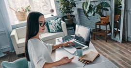 young woman working from home on devices